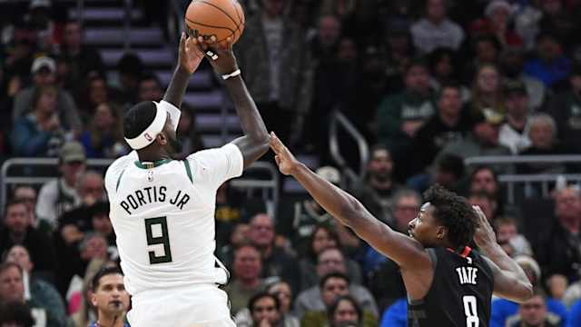 Milwaukee Bucks forward Bobby Portis (9) puts up a shot against Houston Rockets forward Jae'Sean Tate (8)